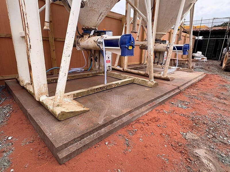 Silo support legs standing on a precast concrete foundation base slab