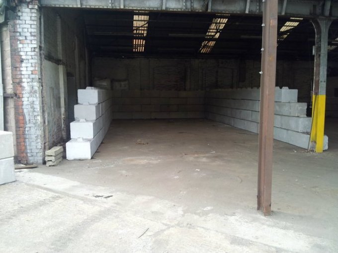 Duo interlocking blocks positioned inside an empty warehouse storage bay