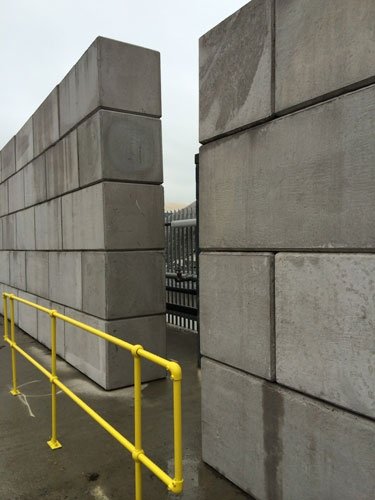 Stacked Legato blocks forming walls beside a yellow safety handrail
