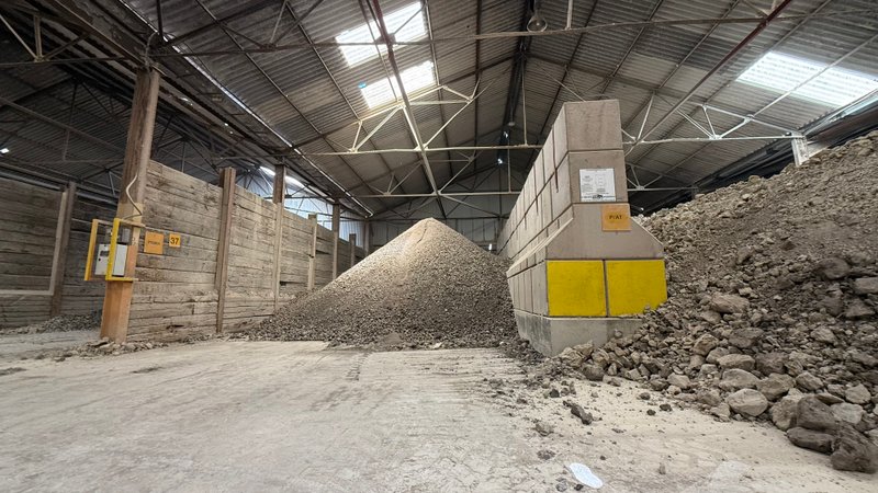 Legato block dividing wall between stone stockpiles inside a storage shed