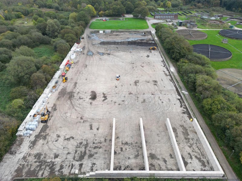 Aerial view of a cleared treatment works site with concrete bay walls being built