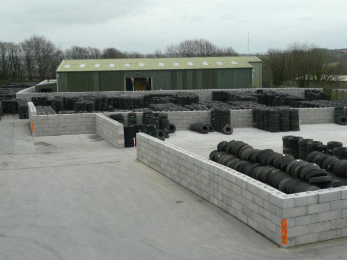 Duo interlocking block bays holding stacked tyres in an outdoor yard