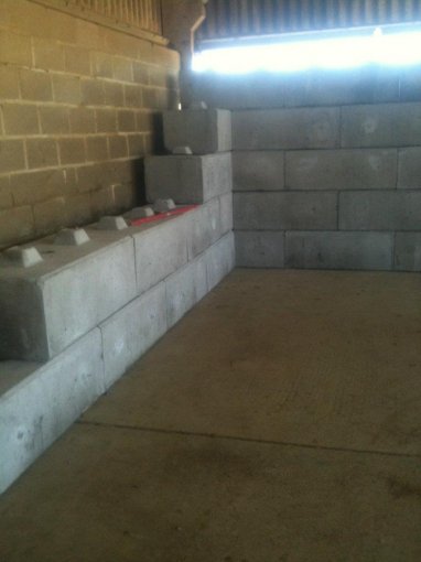 Duo blocks stacked against an internal brick wall inside a storage building