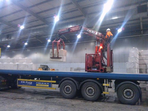 Lorry mounted crane offloading Duo blocks inside a production building