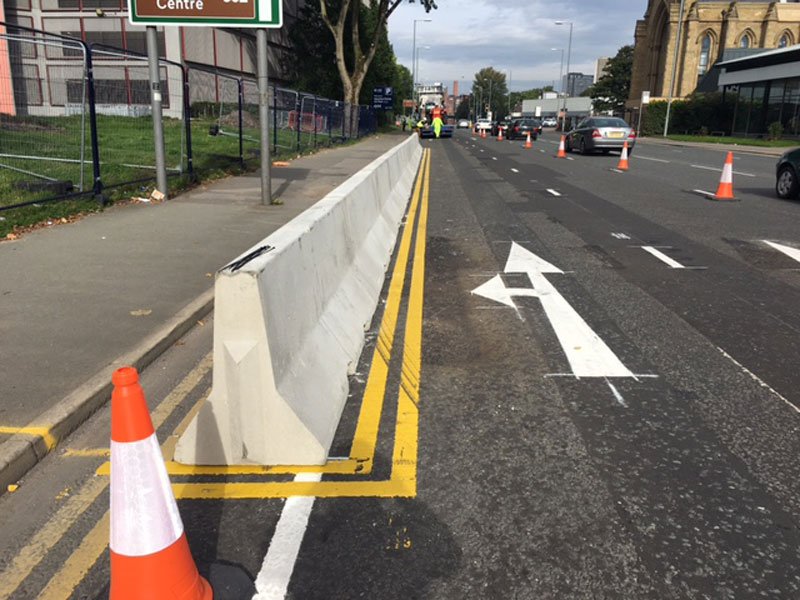 Jersey barrier segregating a coned-off lane on an urban dual carriageway