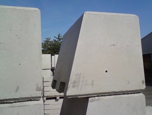 Tapered one-tonne kentledge ballast block standing in a concrete yard
