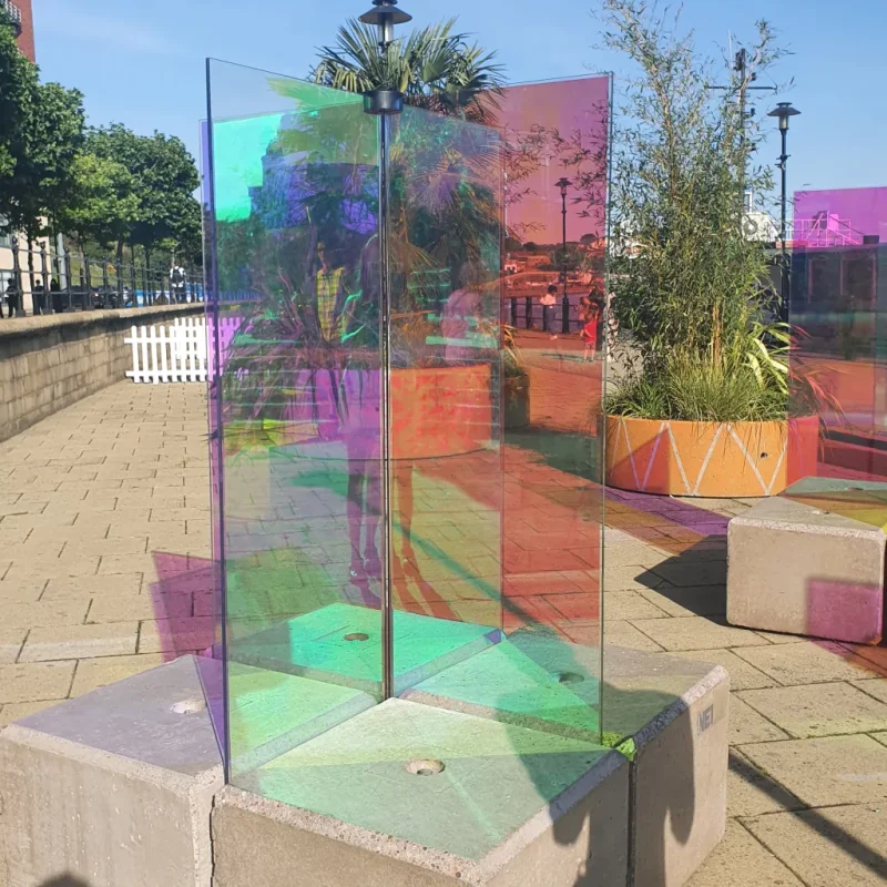 Coloured glass art panels mounted on Duo block bases on a paved quayside