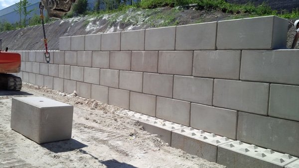 Completed Legato interlocking block retaining wall along a commercial development site