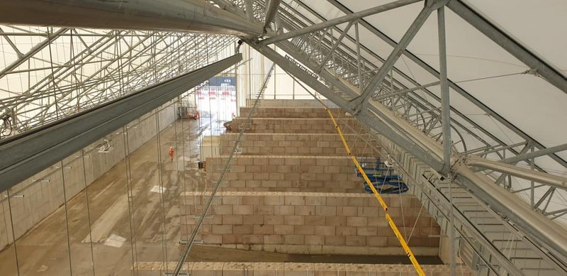 Legato block bay walls forming indoor material storage in a steel-framed building
