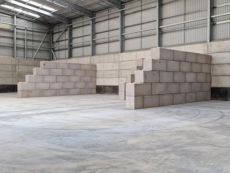 Stepped Legato block walls forming freestanding storage bays inside a warehouse