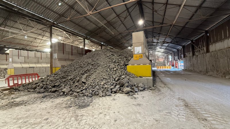 Legato bay walling inside a shed holding a heap of crushed material