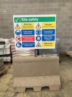 Mini Jersey barrier used as a freestanding base for a site safety sign