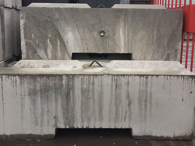 Close-up of a concrete ballast block showing its cast-in lifting anchor slot
