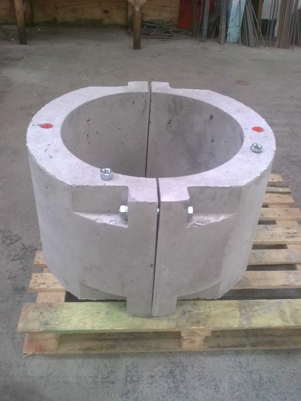 Two-piece precast concrete pipe collar bolted together on a pallet