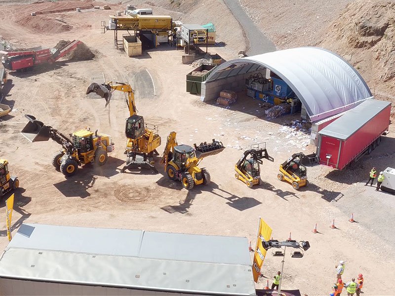 Aerial view of a quarry yard with a block-walled canopy store and plant machinery