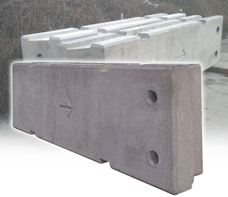 Single temporary vertical concrete barrier unit showing lifting holes and directional arrow