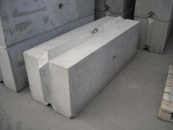 Two plain precast concrete radiation shielding blocks stacked in a store