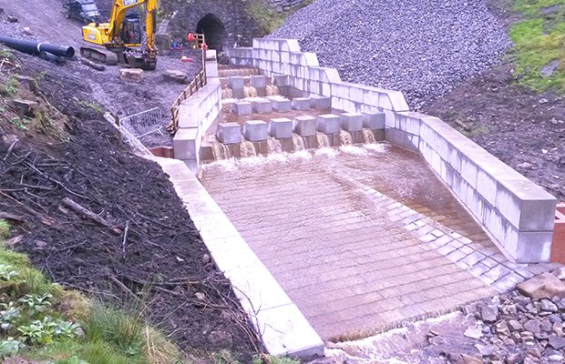 Legato block walling lining a new drainage channel below a railway embankment