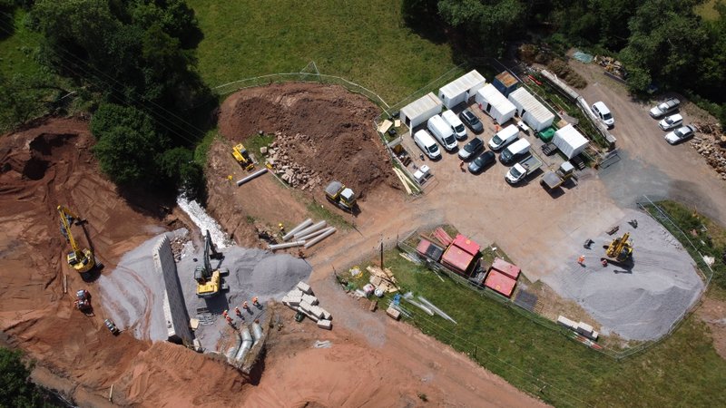 Aerial view of a railway embankment repair with interlocking blocks and excavators