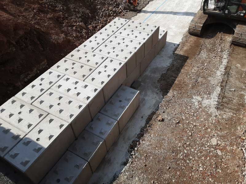 Legato blocks laid out to form the base of a ramp beside an excavator