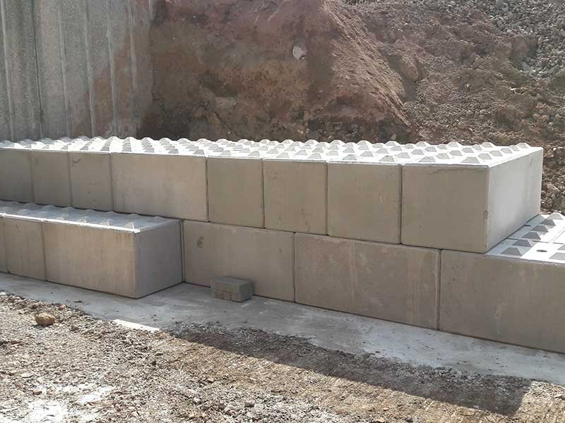 Legato blocks laid against an excavated bank to form a ramp wall