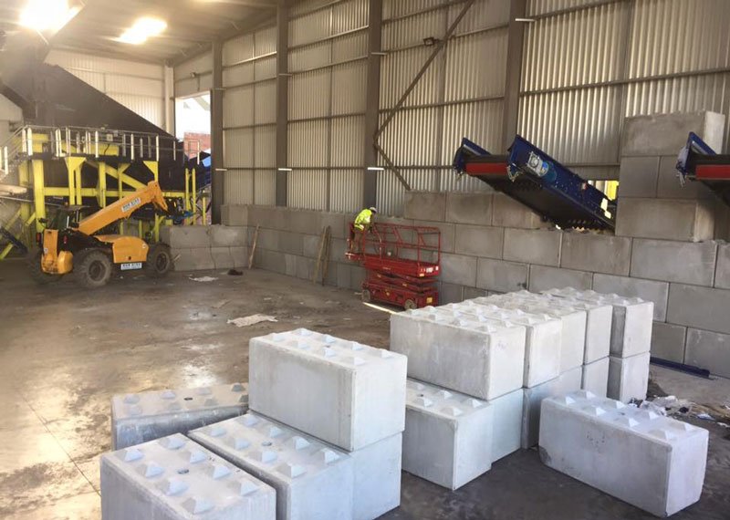 Legato interlocking blocks stacked on a waste facility floor ready for wall building