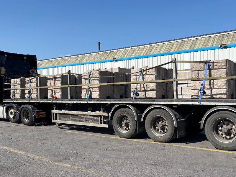 Retainer-Rock units strapped in stacks on a flatbed delivery trailer