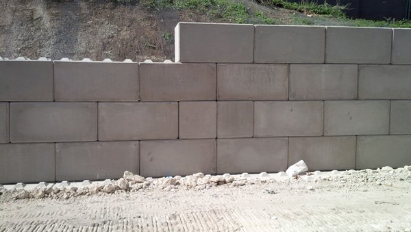 Low Legato block retaining wall running along the foot of an embankment