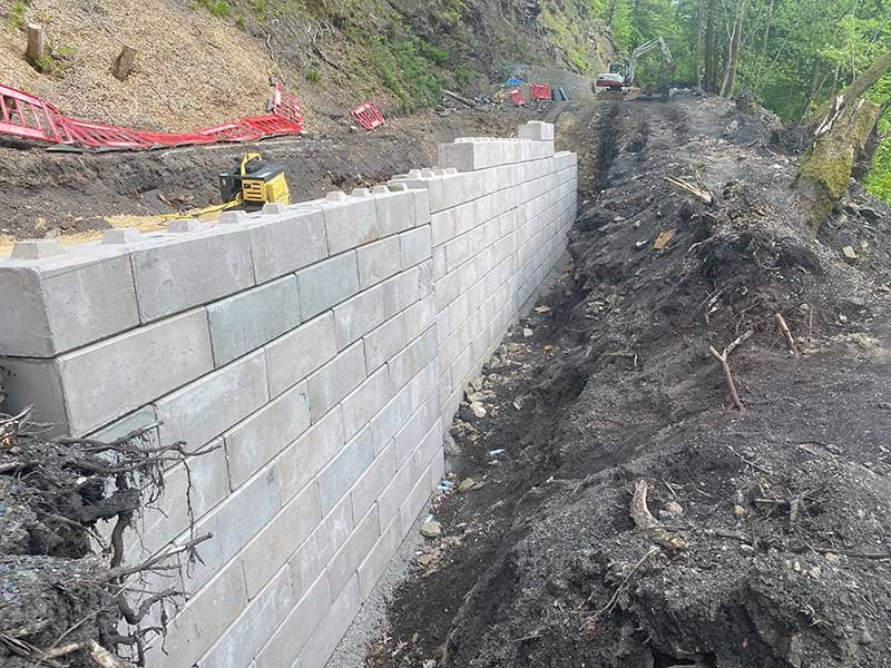 Completed Duo block retaining wall running along an excavated cutting