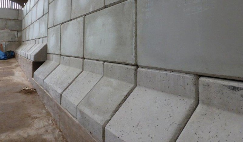 Close view along a Legato block retaining wall running through a barn
