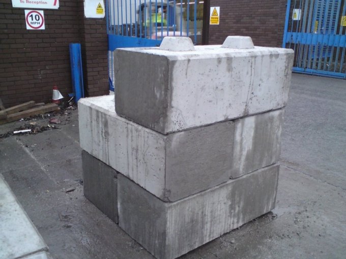 Two Duo counterweight blocks stacked at a gated site entrance