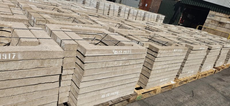 Stacks of two piece concrete seating rings stored in a works yard