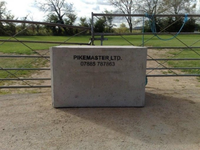 Concrete security block marked Pikemaster Ltd blocking a field gateway