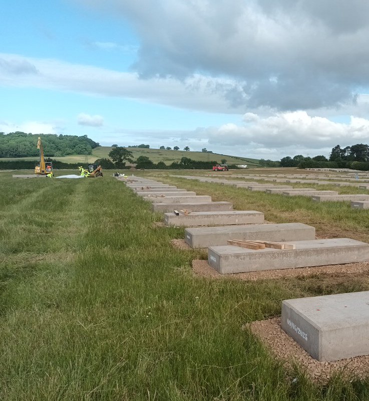 Solar ballast blocks positioned in long rows across open grassland