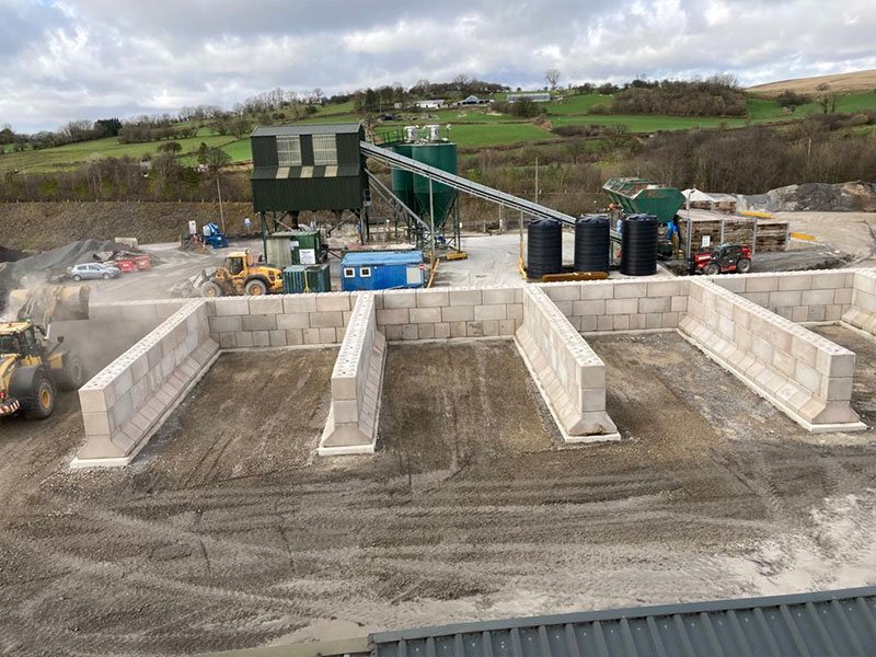 Empty storage bays formed from interlocking blocks at a quarry processing yard