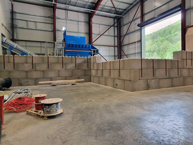 Legato block safety wall enclosing machinery inside an industrial building