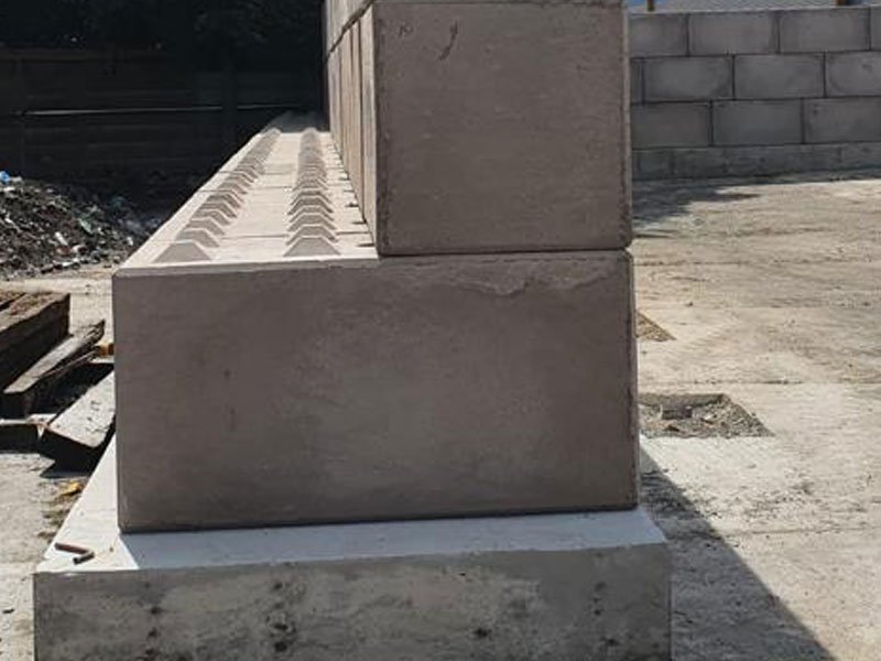 Legato block showing its keyed top face at the start of a storage bay wall