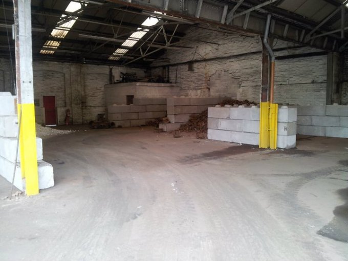 Duo blocks forming scrap storage divisions inside an old industrial building