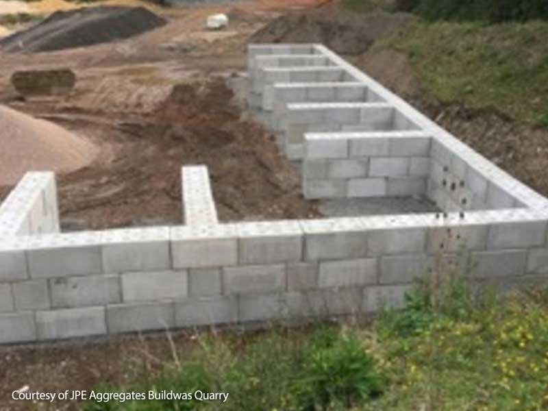 Legato interlocking blocks forming multiple aggregate storage bays at a quarry