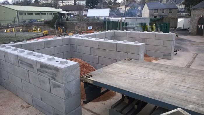 Duo blocks forming a row of open material bays on a yard