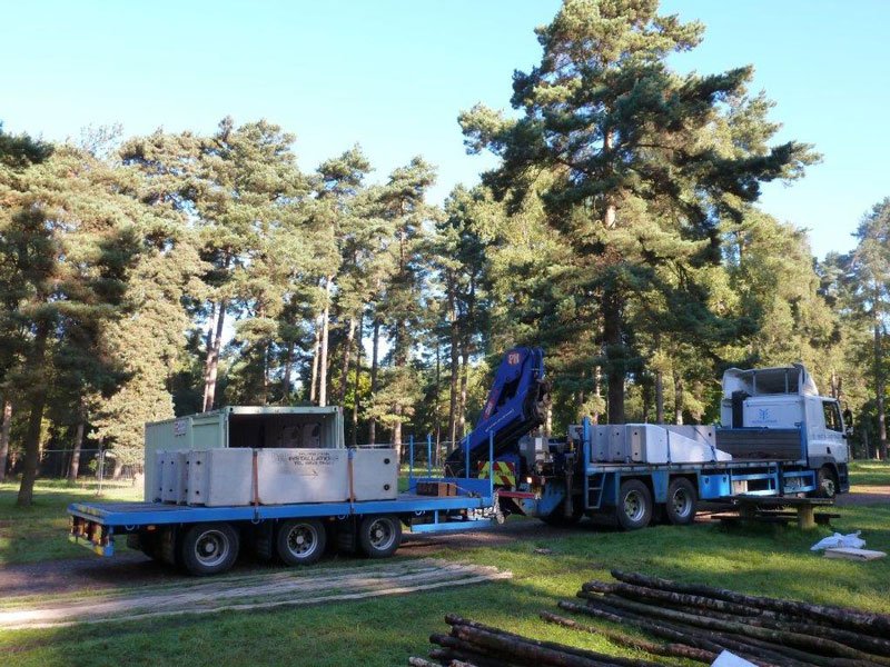 Lorries delivering temporary vertical concrete barriers for an event set up