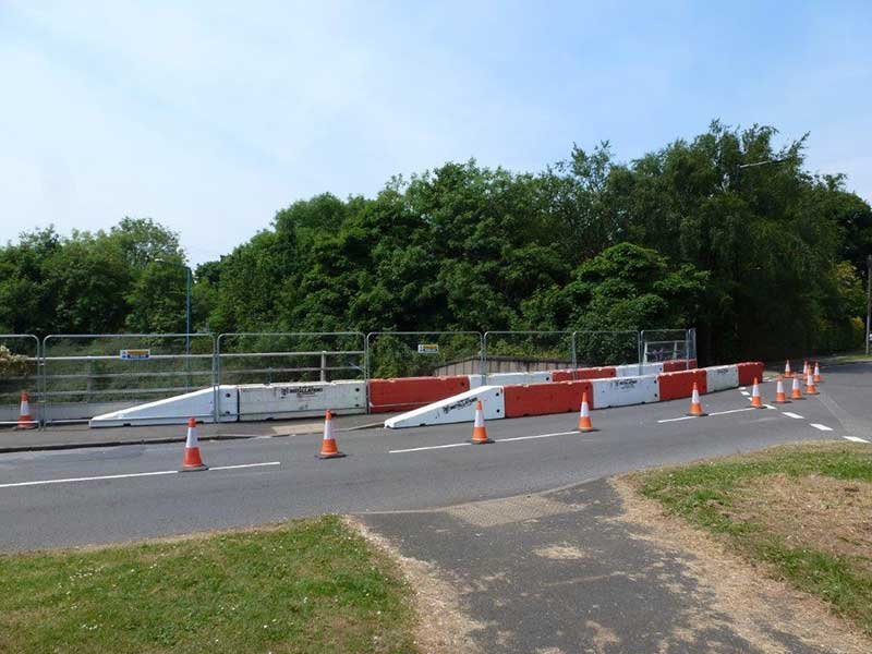 Temporary vertical concrete barriers and cones closing part of a road