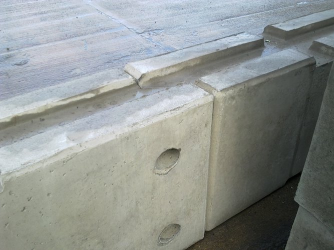 Close-up of the interlocking joint between two concrete barrier sections