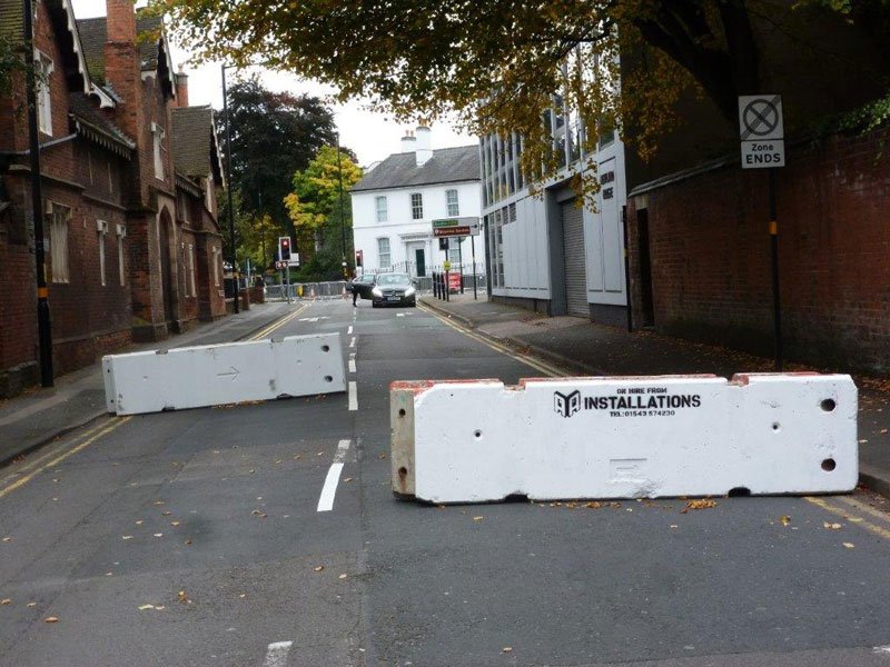 Temporary vertical concrete barriers closing a residential street to traffic