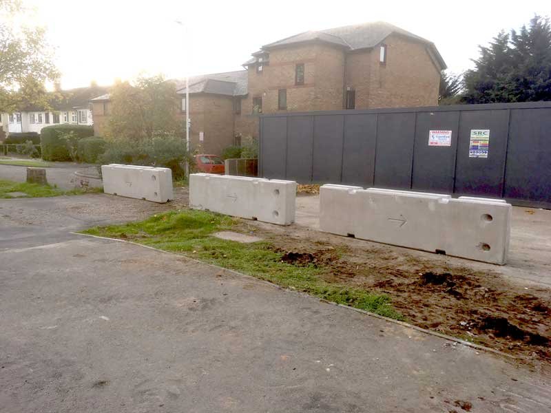 TVCB barriers set in front of site hoarding beside new houses
