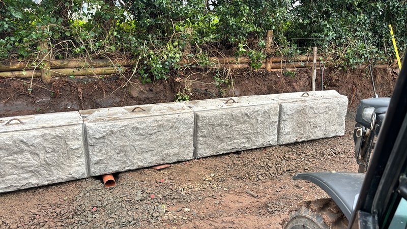 Rock-faced Vee-Rock walling units set in a low run along a bank