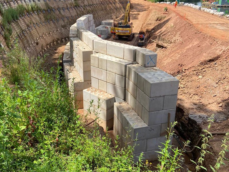 Stepped interlocking block structure under construction on a river fish pass