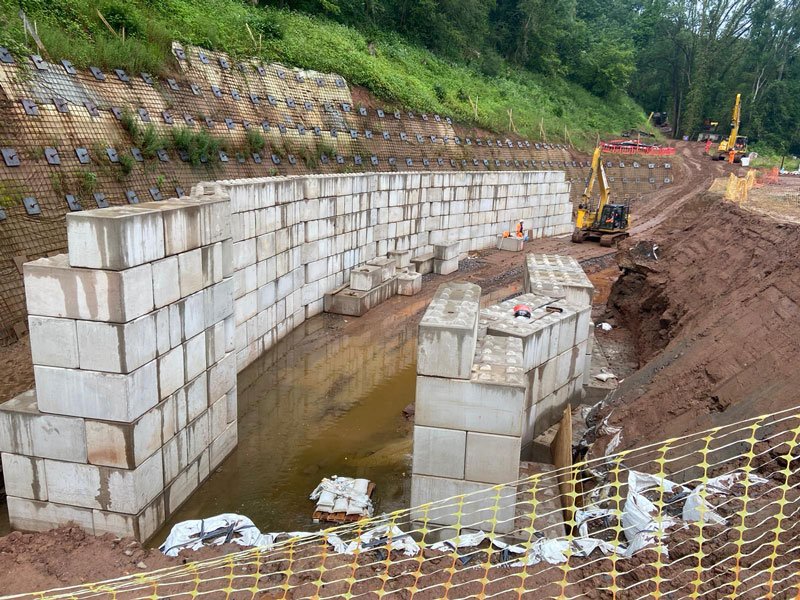 Interlocking block chamber walls under construction in a river fish pass