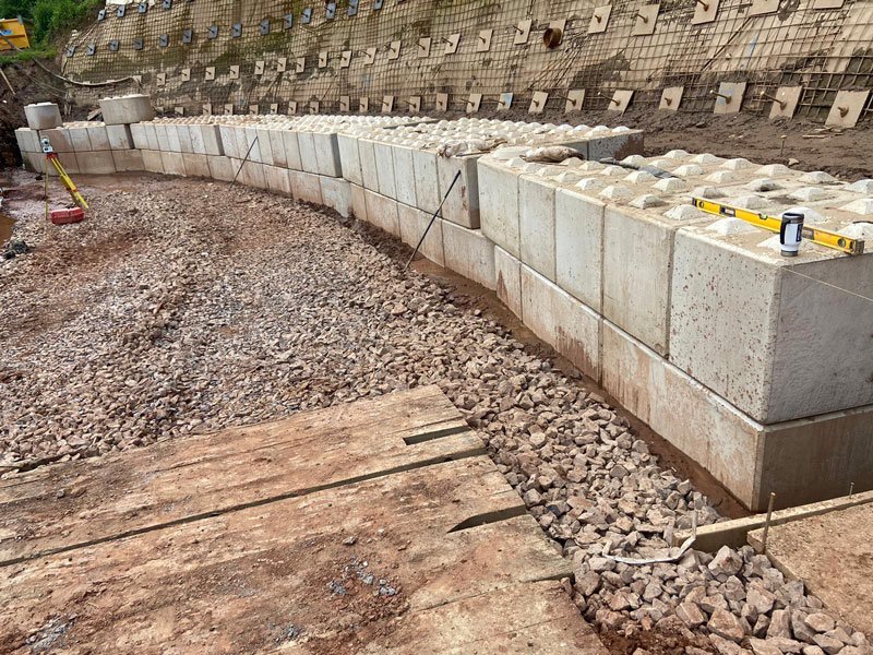 Line of Legato blocks forming a channel wall with stone fill alongside