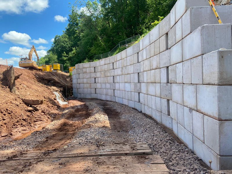 Curved Legato block retaining wall built along a freshly excavated cutting